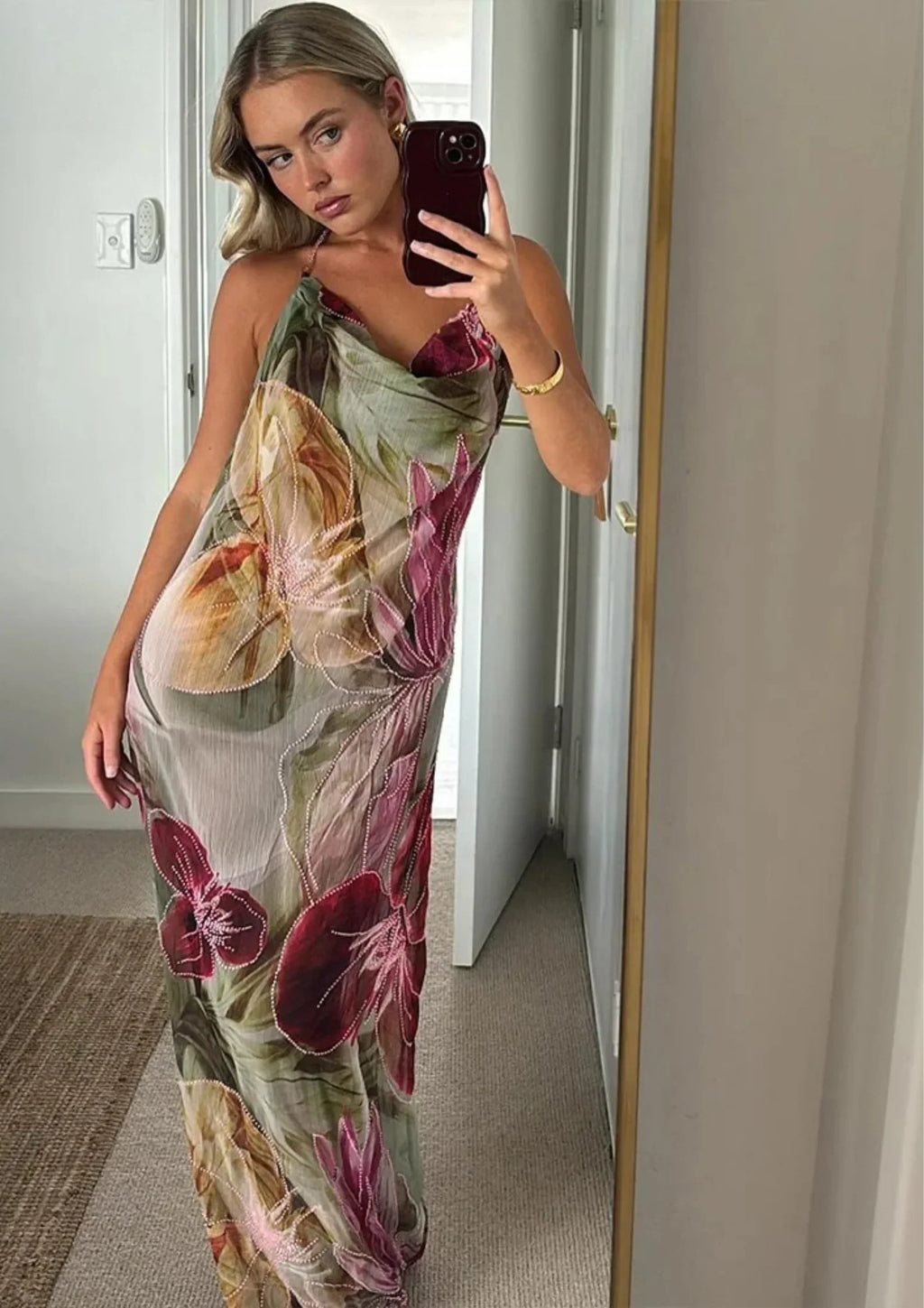 Women's sleeveless floral maxi dress in lightweight fabric features a side slit for easy movement and a vibrant floral print.