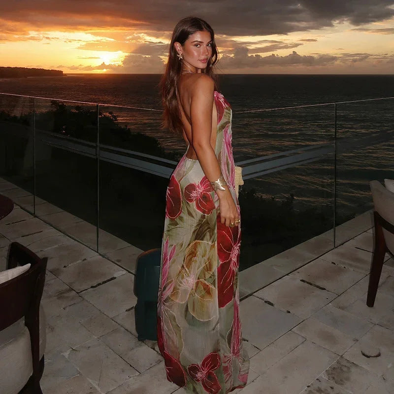 Women's sleeveless floral maxi dress in lightweight fabric, featuring a side slit and vibrant floral patterns for a flowy…