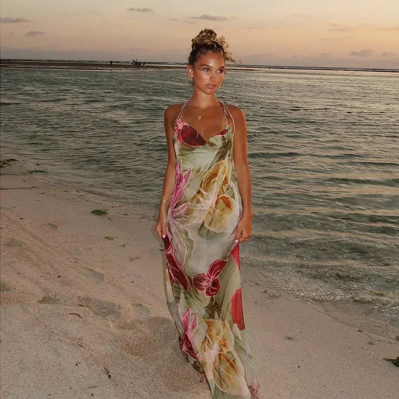 Women’s sleeveless floral maxi dress made of lightweight fabric, featuring a side slit and a vibrant floral pattern.