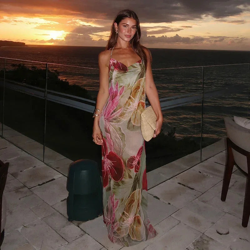 Women’s sleeveless floral maxi dress with side slit, made from lightweight fabric featuring a vibrant floral pattern.