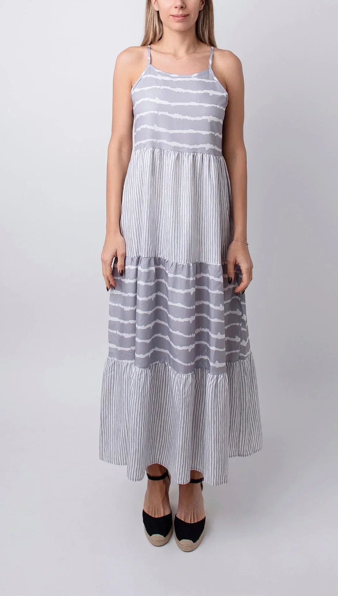 Women’s sleeveless grey striped midi dress with tiered design, made of lightweight cotton for casual comfort.