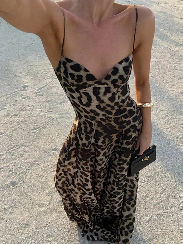 Women’s sleeveless leopard print maxi dress featuring thin straps and lightweight fabric, perfect for warm weather outings.