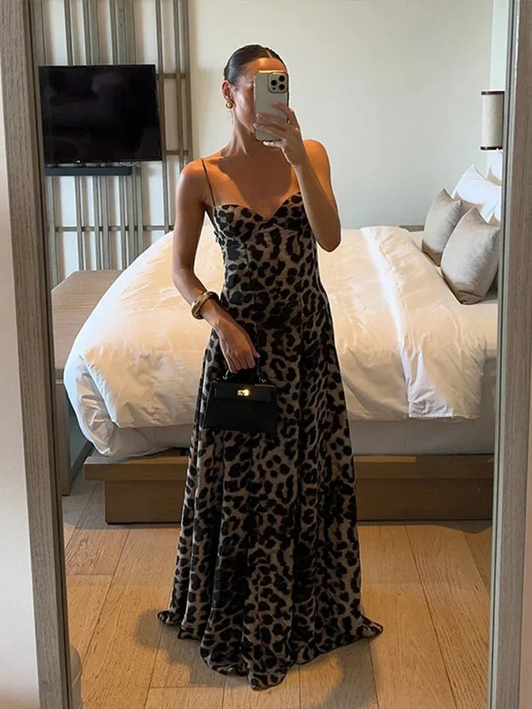 Women’s sleeveless leopard print maxi dress with thin straps, made of lightweight fabric for comfort and easy movement.