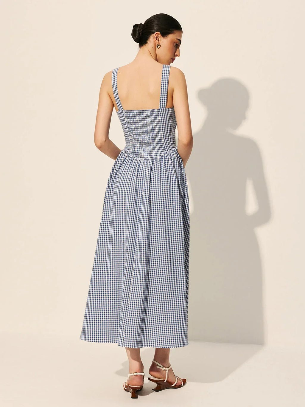 Women's sleeveless navy gingham midi dress featuring a square neckline, crafted from lightweight cotton for comfort.