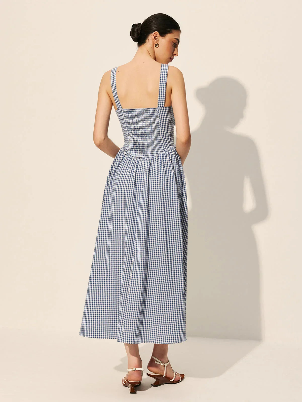 Women's sleeveless navy gingham midi dress featuring a square neckline, crafted from lightweight cotton for comfort.