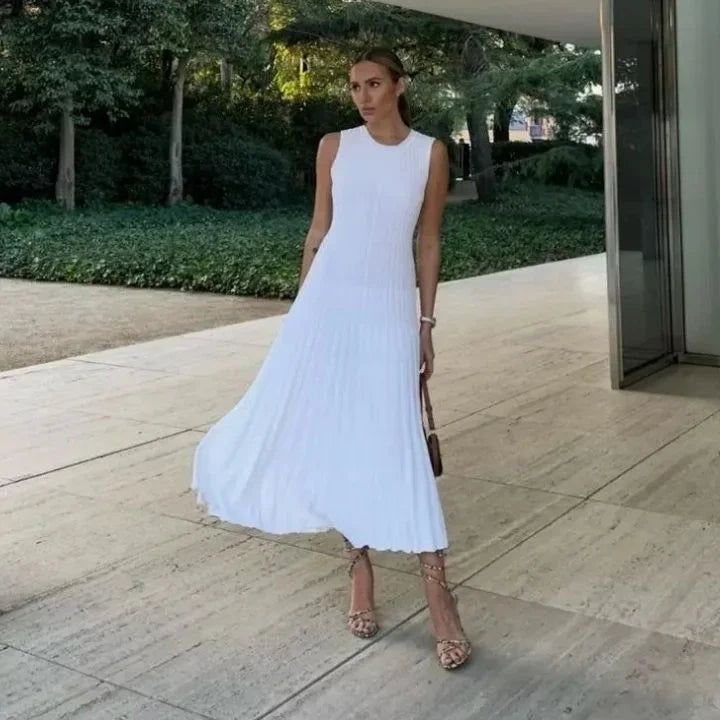 Women’s sleeveless pleated A-line maxi dress in soft fabric, featuring a flowy silhouette and elegant pleat detailing.