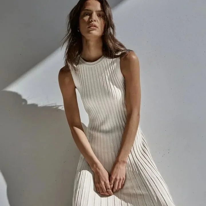 Women’s sleeveless pleated A-line maxi dress in lightweight fabric, featuring a flowy silhouette and elegant pleating…