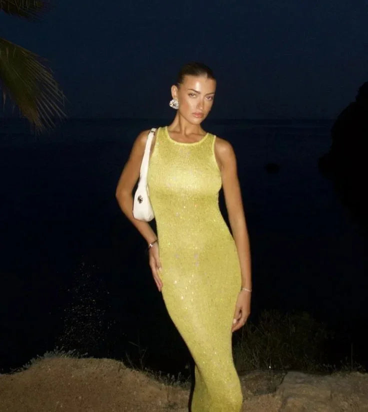 Women’s sleeveless fitted maxi dress in shimmering fabric, featuring a sleek design and comfortable silhouette for any…