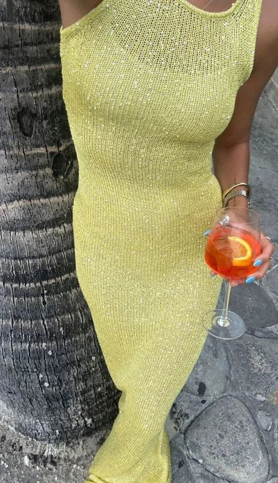 Women’s sleeveless fitted maxi dress in shimmering fabric, featuring a sleek silhouette and elegant floor-length design.