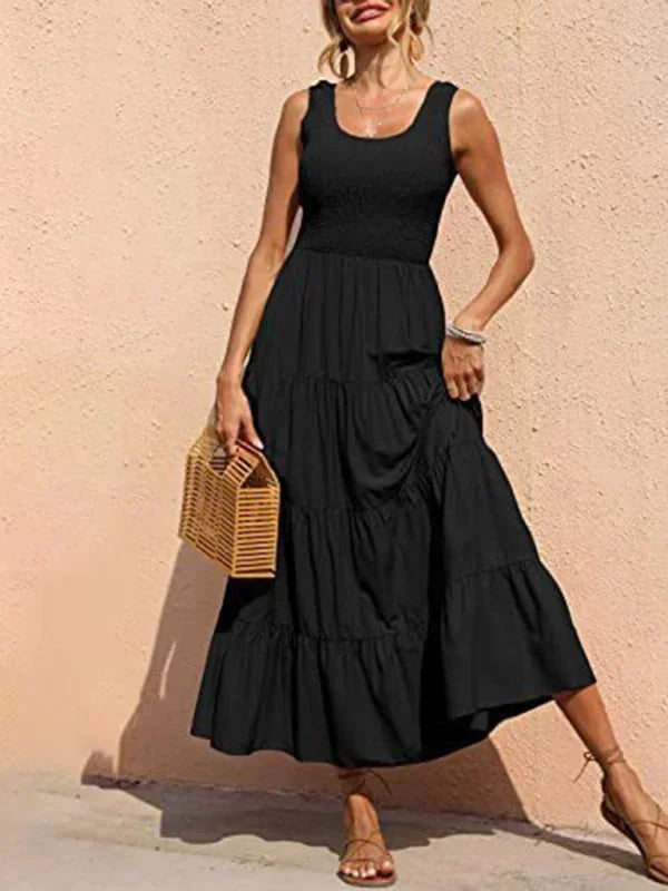 Black sleeveless tiered maxi dress with a smocked bodice, crafted from lightweight fabric for comfortable summer wear.