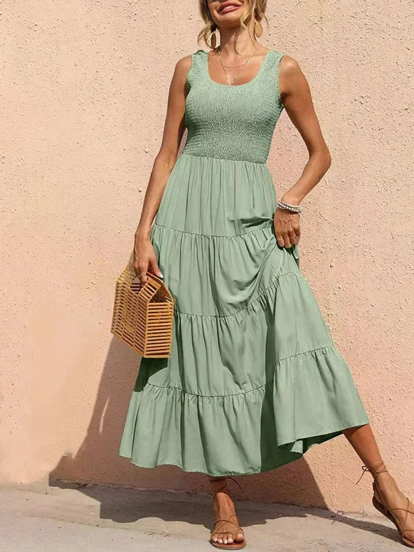 Green women's sleeveless tiered maxi dress featuring a smocked bodice and lightweight fabric, ideal for casual summer…
