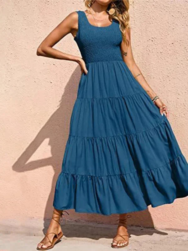 Peacock blue sleeveless maxi dress with tiered design and smocked bodice, made from soft, breathable fabric.