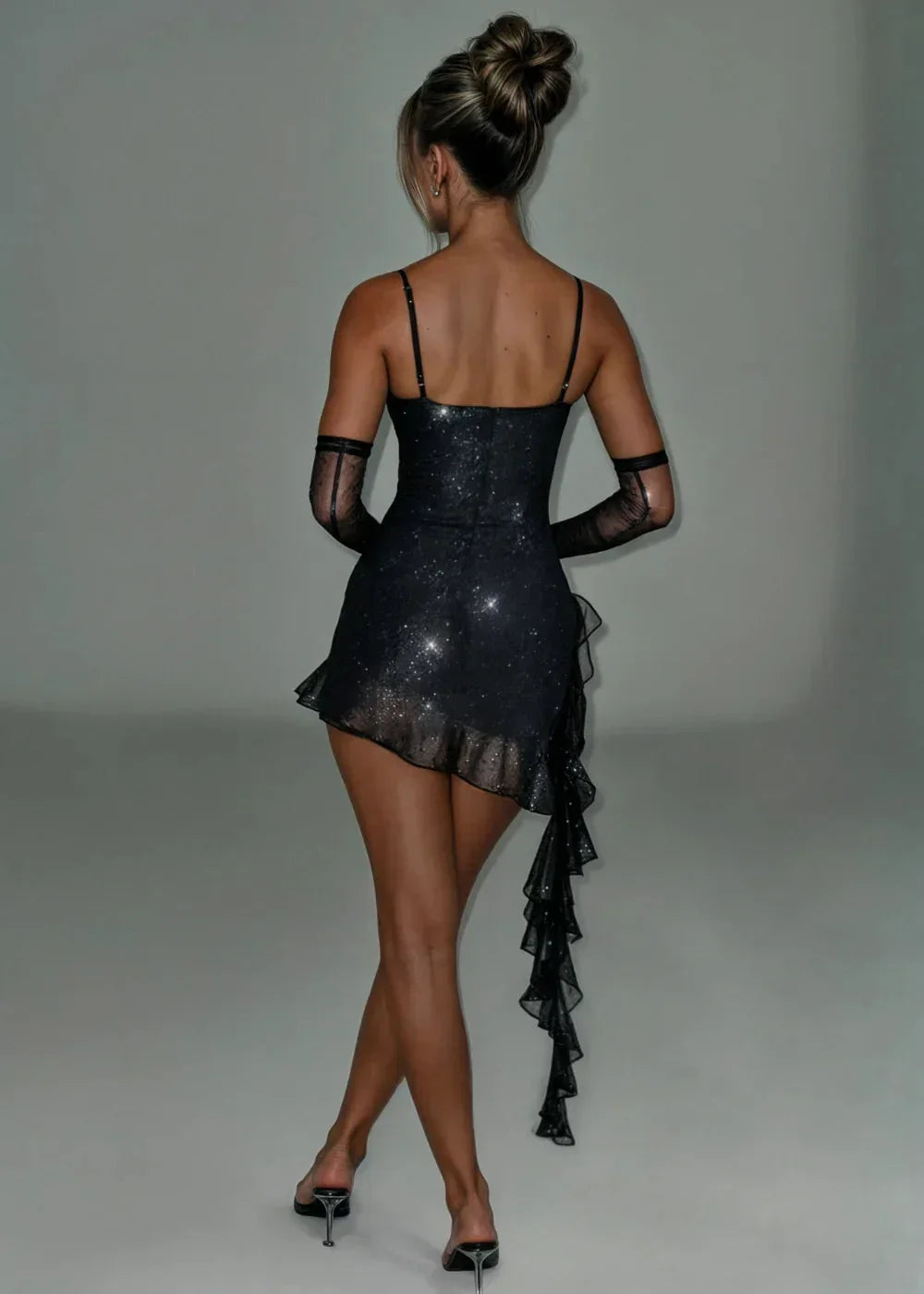 Women’s sparkling asymmetric mini dress made of soft fabric, featuring detachable sleeves for versatile styling and a unique…