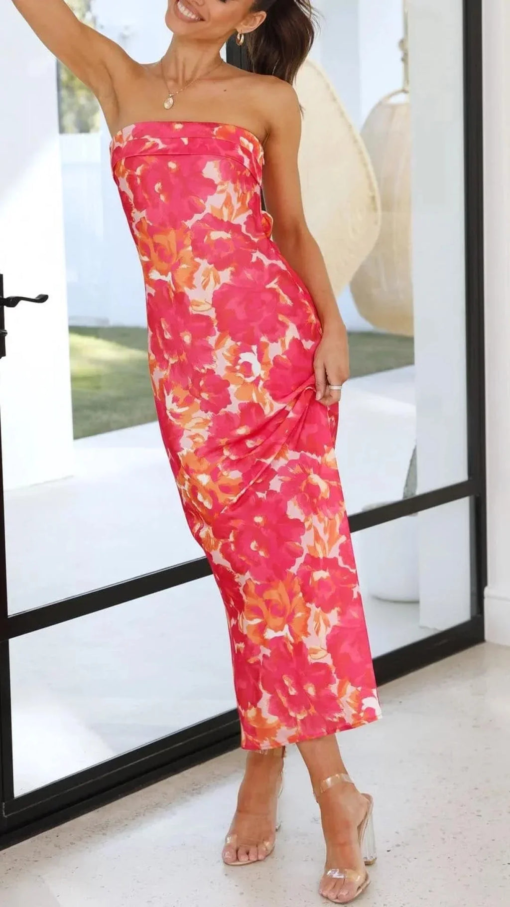 Women’s strapless floral maxi dress with bold print, made from lightweight fabric, featuring a flowing silhouette and…