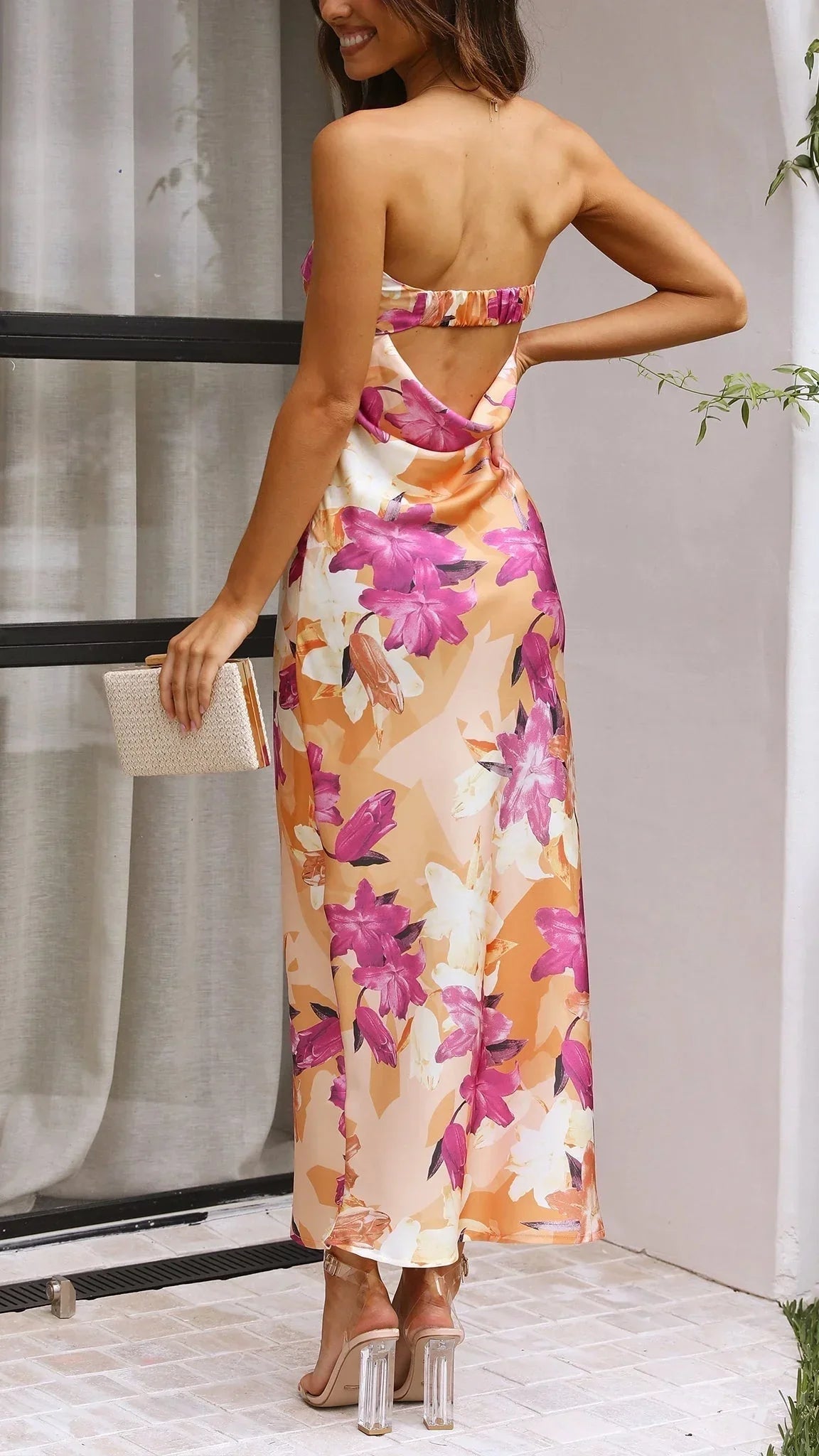 Women’s strapless floral maxi dress made from lightweight fabric, featuring a vibrant bold print and flowy silhouette.