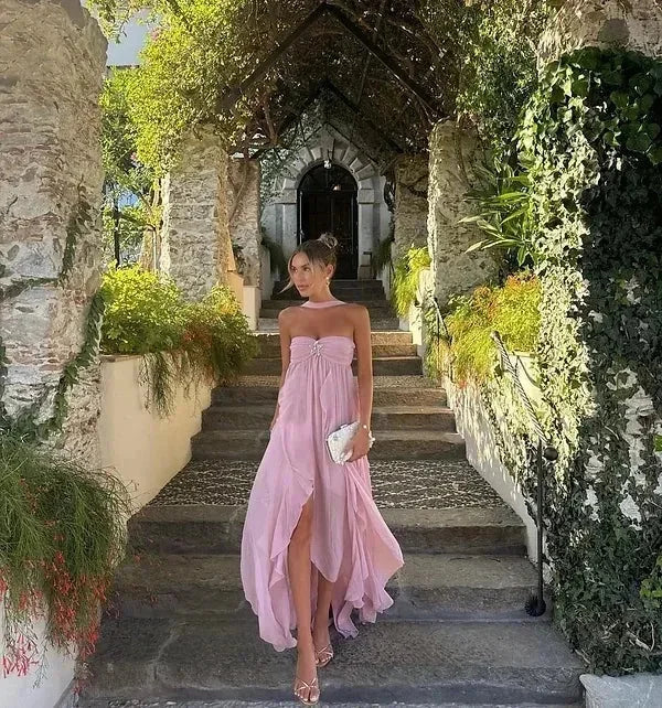 Women’s strapless maxi dress made from lightweight fabric, featuring flowing ruffles for added movement and an elegant…