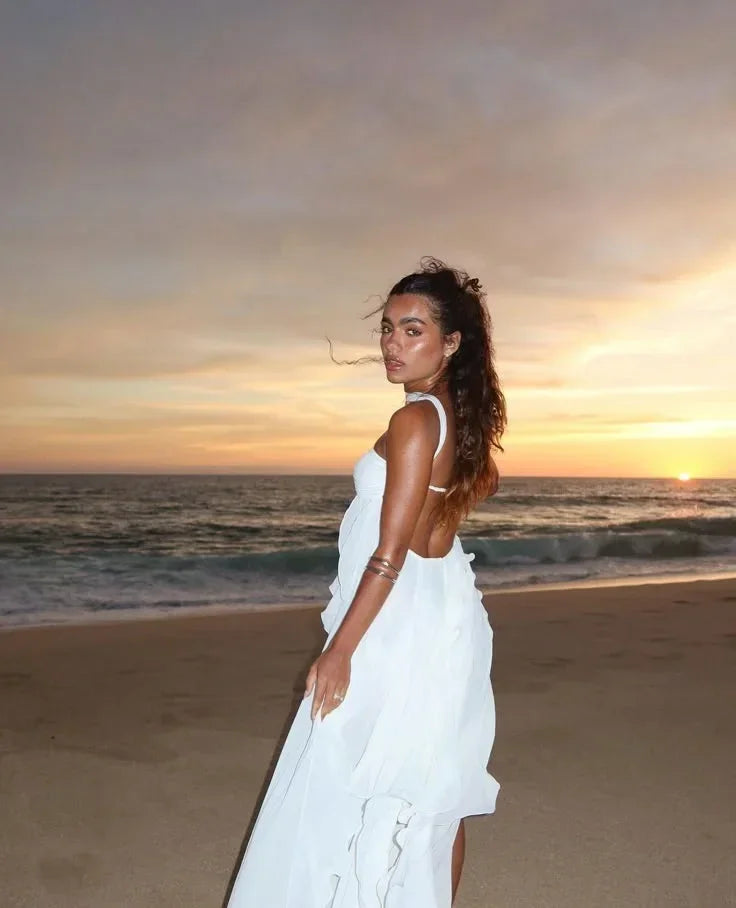 Alt text: Women’s strapless maxi dress in soft fabric, featuring elegant flowing ruffle details for a breezy summer style.