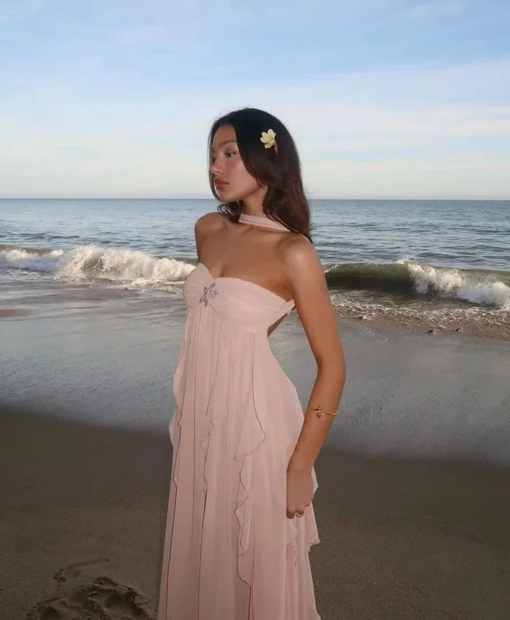 Pink strapless maxi dress with flowing ruffle details, made from lightweight fabric for a comfortable fit and elegant…
