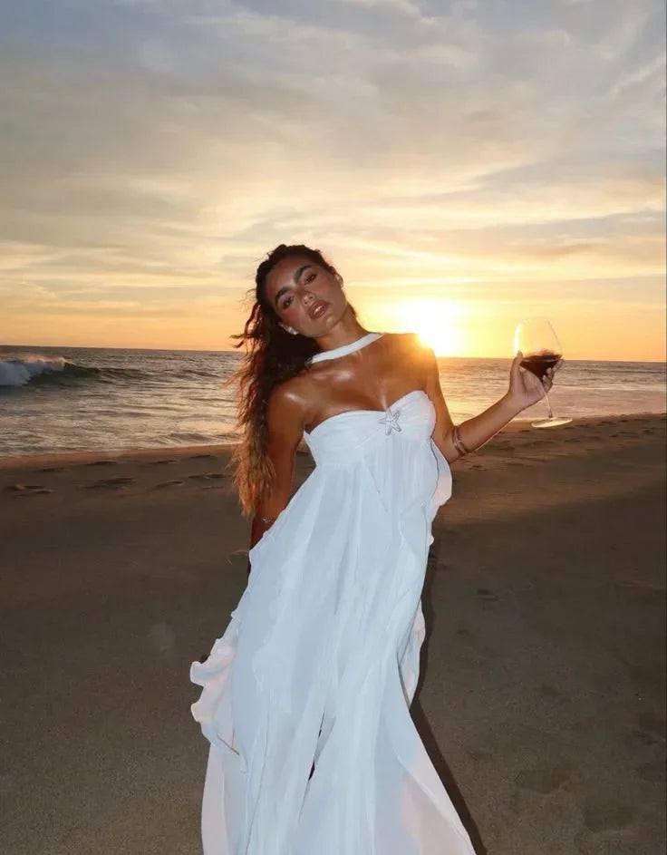 White strapless maxi dress featuring flowing ruffle details, made from lightweight fabric for a comfortable fit.