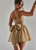 Gold strapless mini dress featuring an elegant bow detail, crafted from soft fabric for a flattering fit and comfortable…