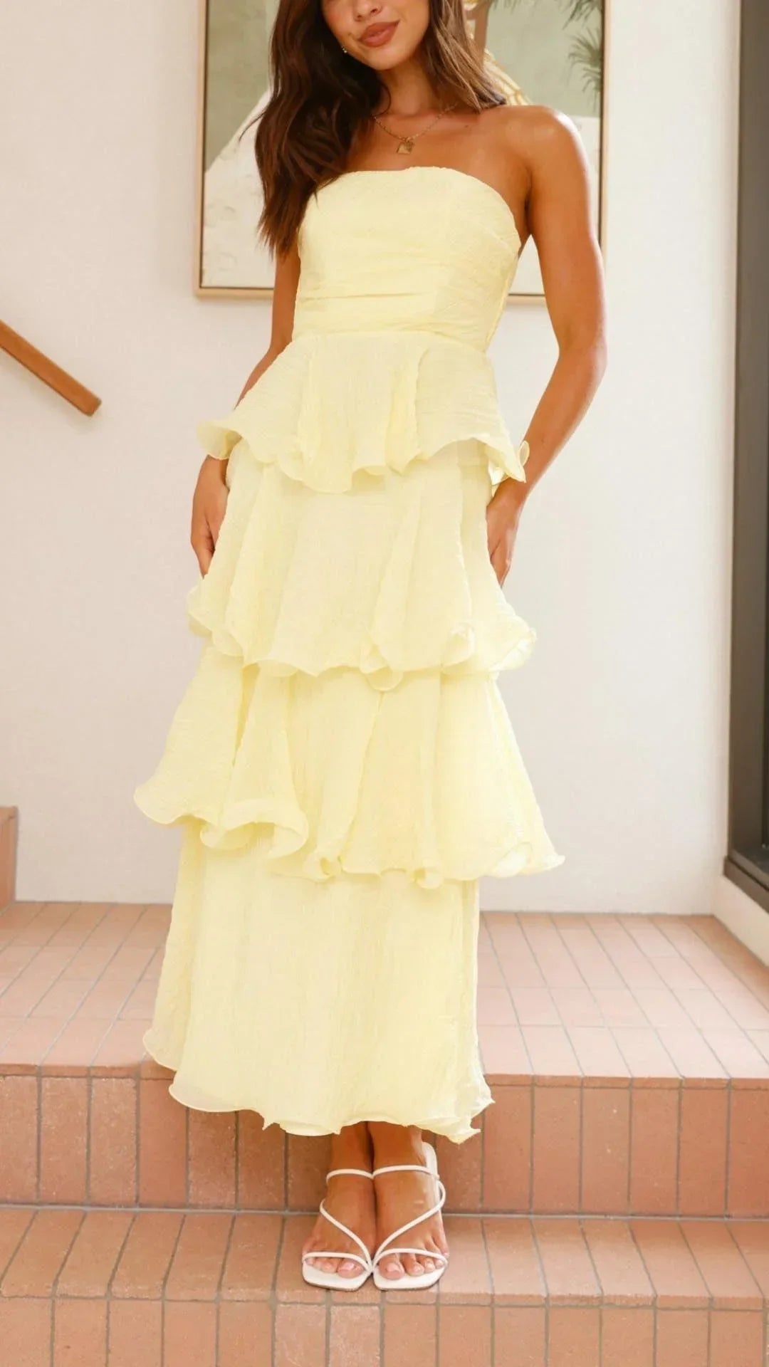 Yellow strapless maxi dress with tiered design and elegant ruffles, made from lightweight, breathable fabric for comfort.