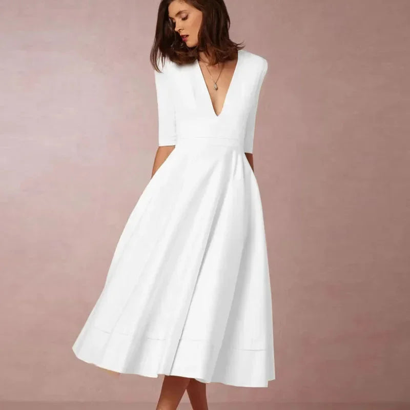 White women's midi dress with fitted bodice, v-neckline, and soft fabric for a comfortable and stylish fit.