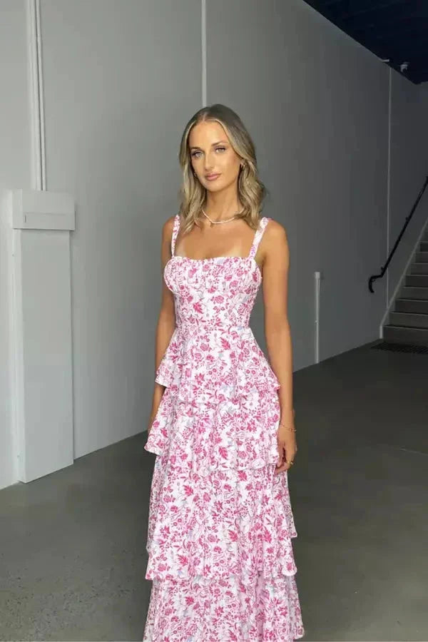 Pink women's tiered floral maxi dress featuring a bow, adjustable straps, and lightweight, breathable fabric for comfort.