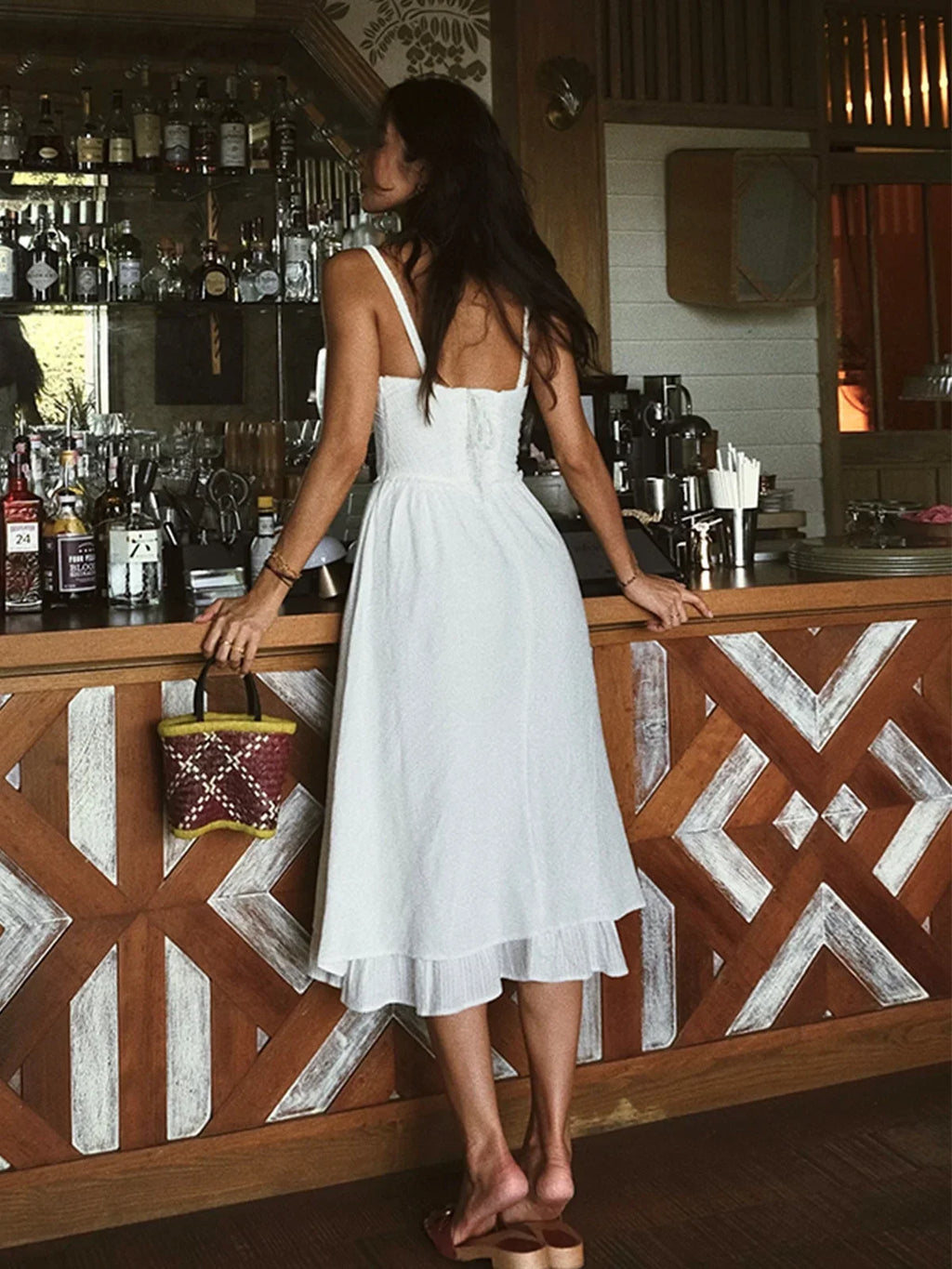 Women’s tiered midi dress in soft fabric featuring ruching and adjustable straps for a customizable fit and flowy silhouette.
