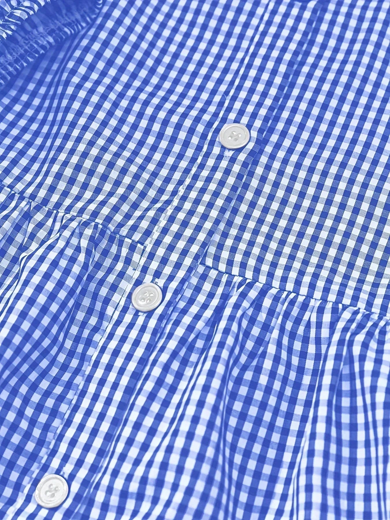 Women's tiered mini dress with button details, collar, and lightweight fabric, perfect for casual outings.