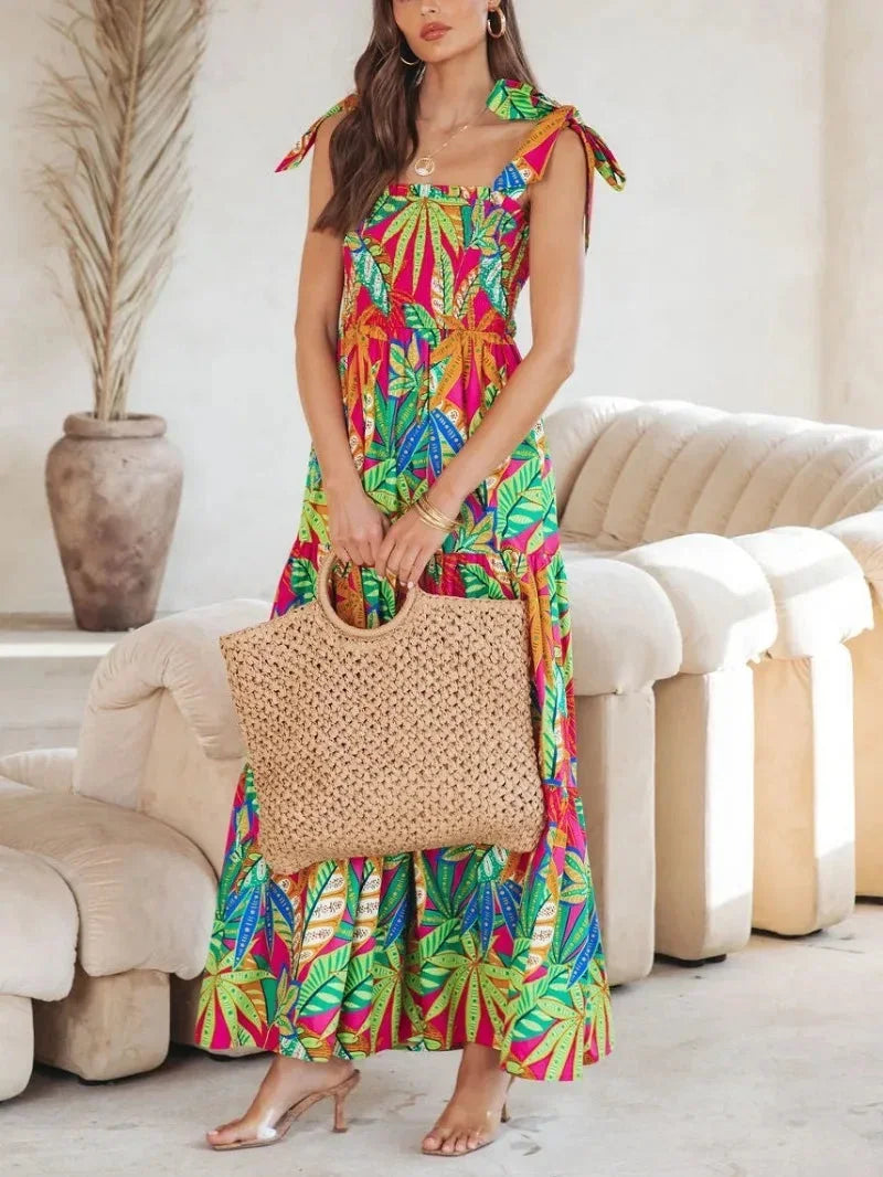 Green tropical print sleeveless maxi dress, featuring tie straps and lightweight fabric for comfort and breathability.
