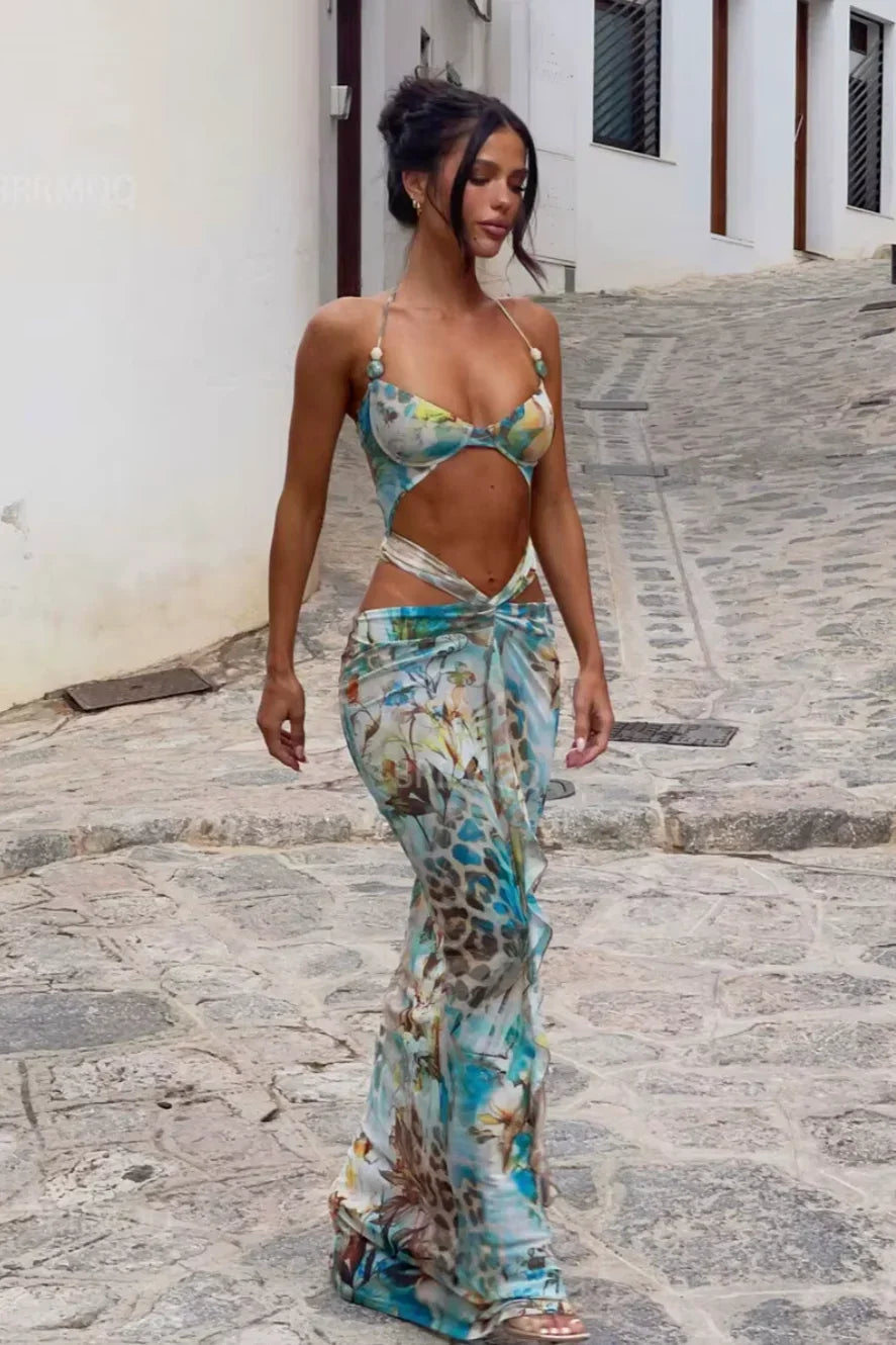 Women’s turquoise maxi dress with floral patterns, featuring cutout details and breathable fabric for comfort and style.