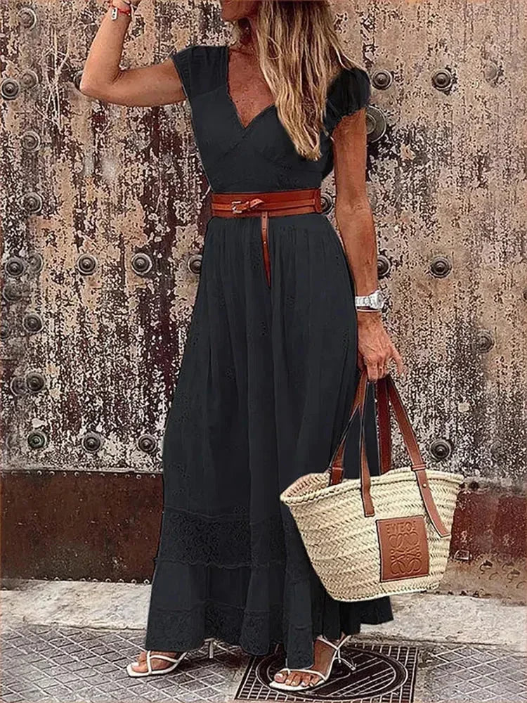 Women's v-neck belted lace maxi dress with cap sleeves, featuring delicate lace fabric and a flattering silhouette.