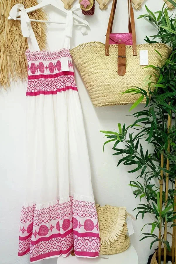 Women's white maxi dress featuring pink tribal patterns, made of lightweight cotton for comfort and breathability.