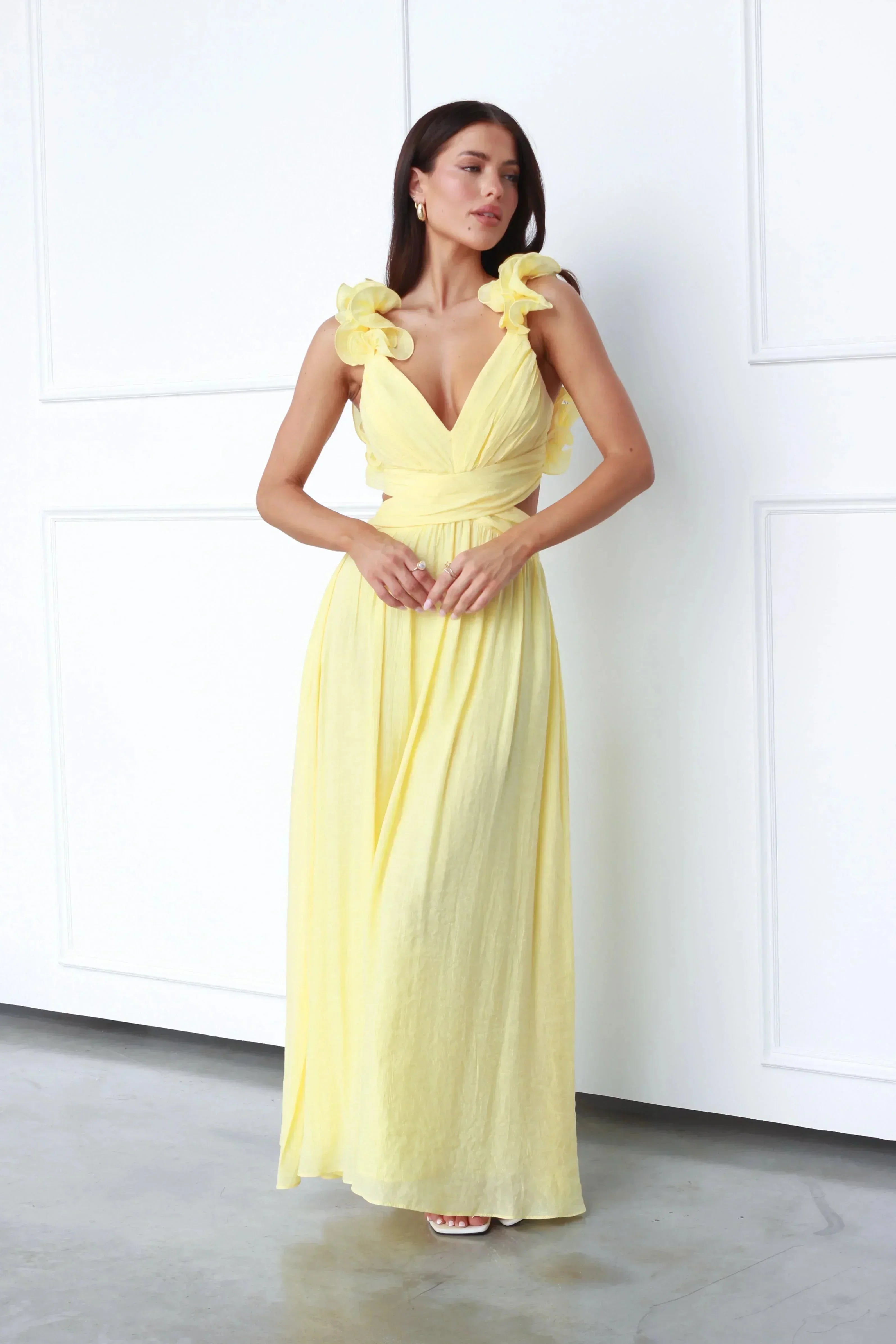 Women’s yellow maxi dress featuring floral shoulder details, made of soft cotton, perfect for casual outings or summer…