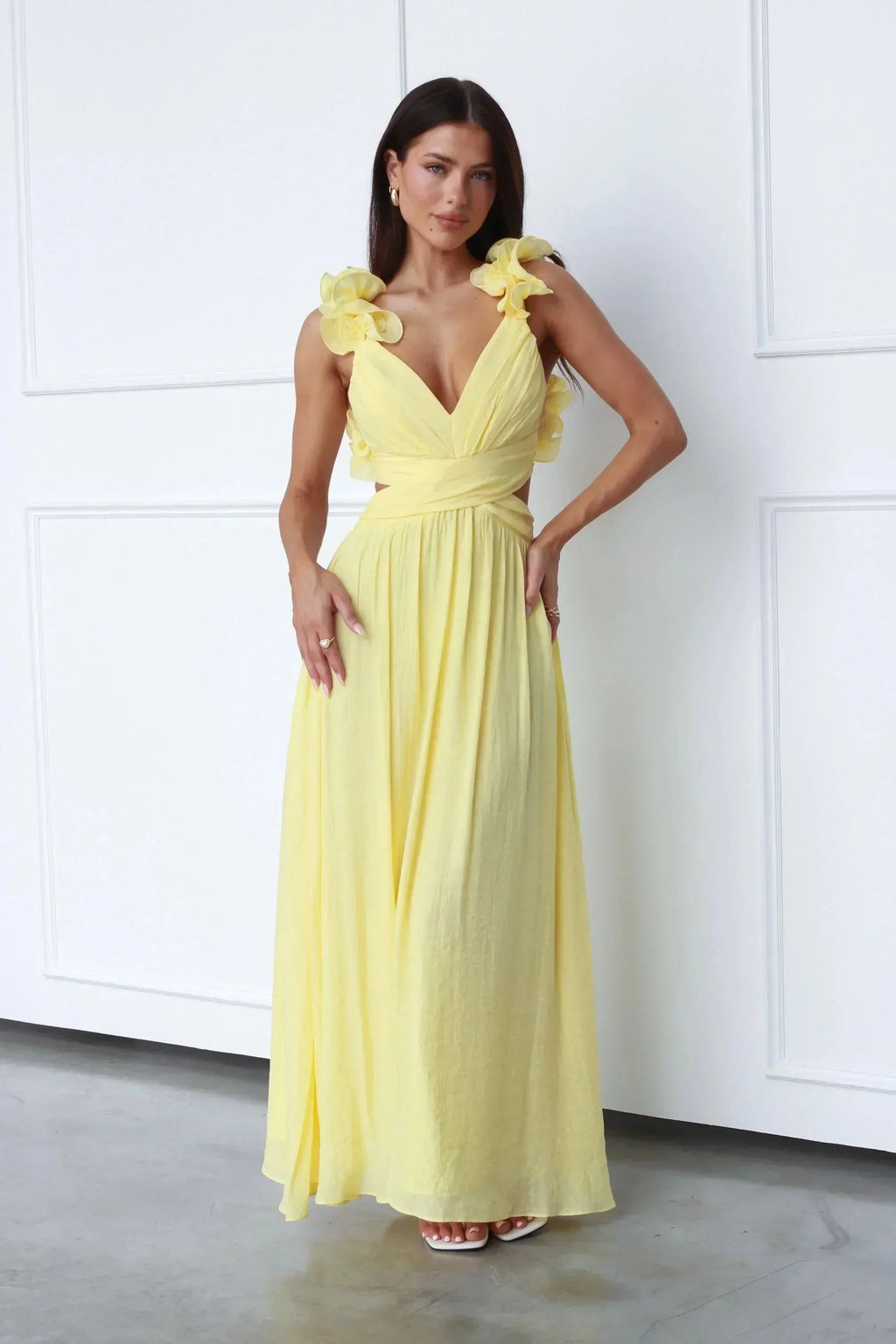 Women’s yellow maxi dress featuring floral shoulder details, made from lightweight fabric for a comfortable, flowy fit.
