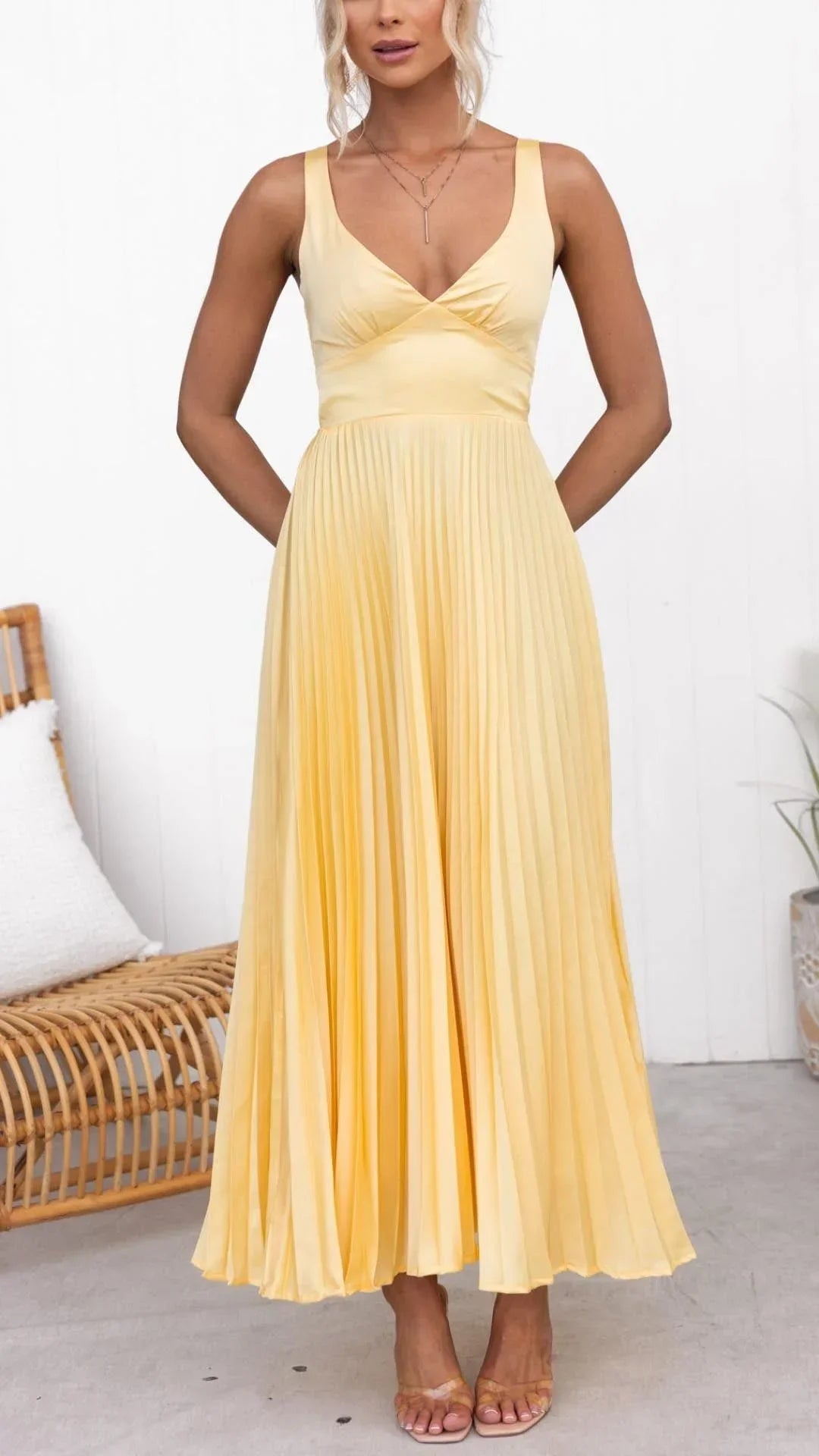 Women’s yellow pleated maxi dress featuring a v-neck, wide straps, and lightweight fabric for comfort and style.