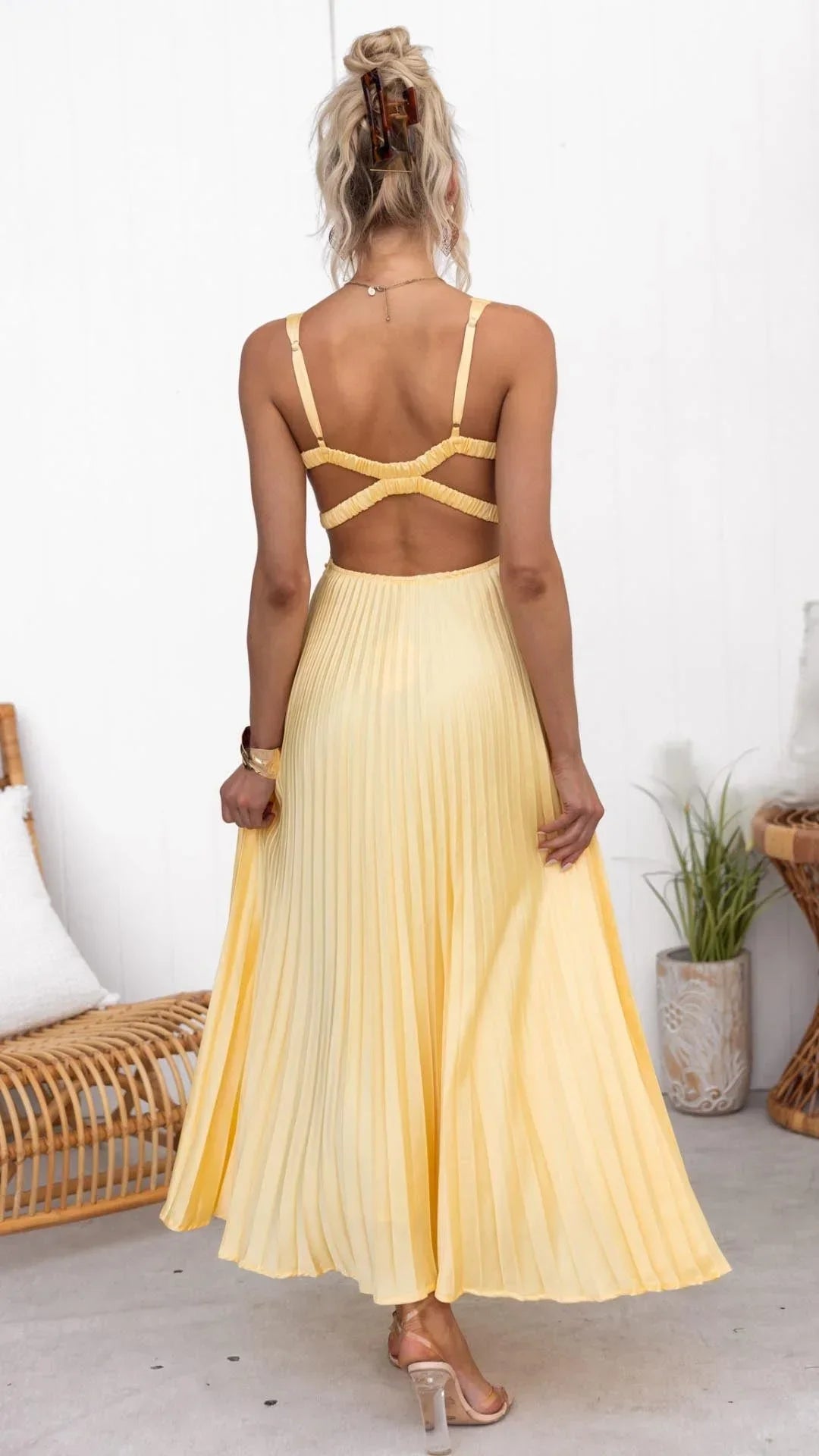 Women’s yellow pleated maxi dress featuring a v-neck, wide straps, and lightweight fabric perfect for warm weather.