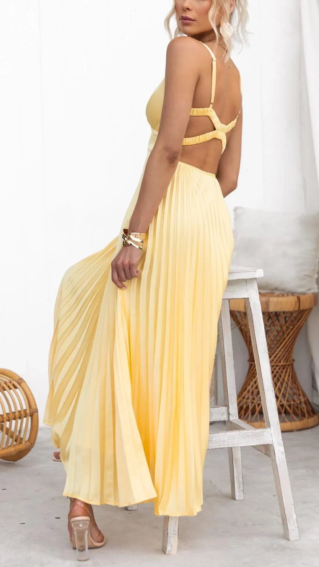 Women’s yellow pleated maxi dress featuring a v-neck, wide straps, and a flowy silhouette made from soft, breathable fabric.